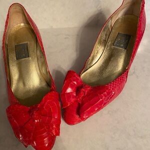 Red snake skin-embossed pump with bow on toe by J. Renee.